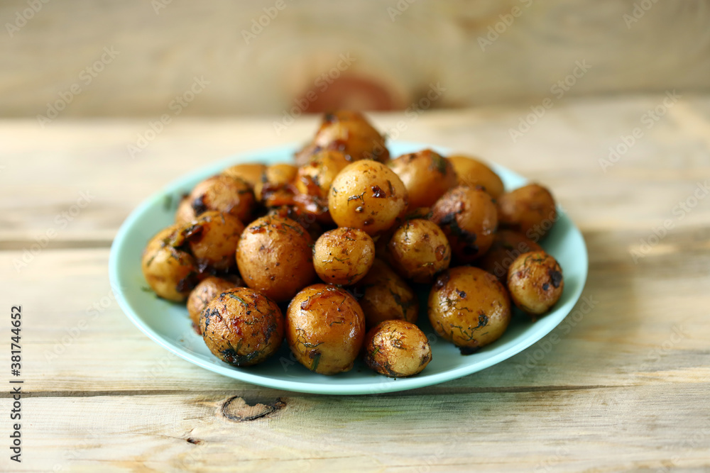 Selective focus. Baked potatoes in their skins. Mini potatoes in a plate. Healthy food. Selective focus. Baked potatoes in their skins. Mini potatoes in a plate. Healthy food.