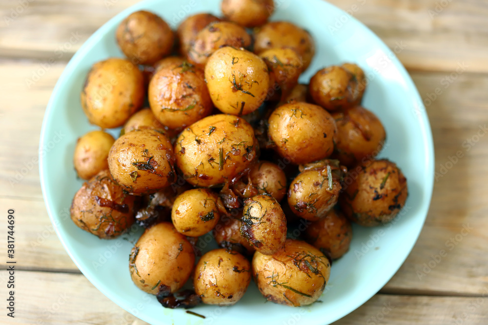 Selective focus. Baked potatoes in their skins. Mini potatoes in a plate. Healthy food. Selective focus. Baked potatoes in their skins. Mini potatoes in a plate. Healthy food.