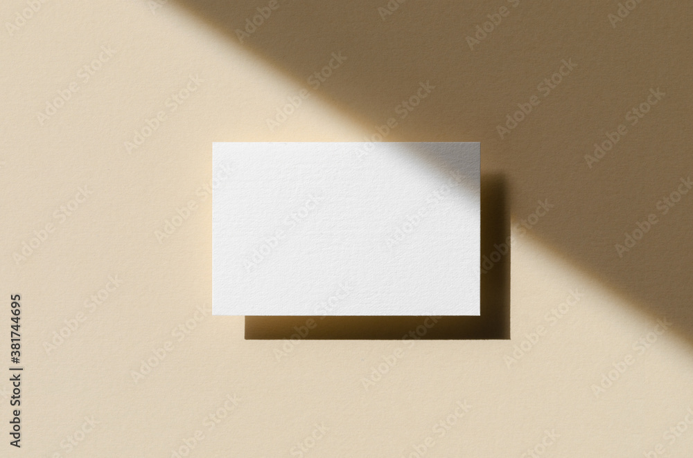 Business card mockup on a beige background with shadow overlay. 85x55 mm. Business card mockup on a beige background with shadow overlay. 85x55 mm.