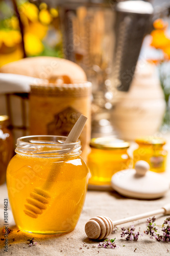 Linden honey in a glass jar with rustic decor