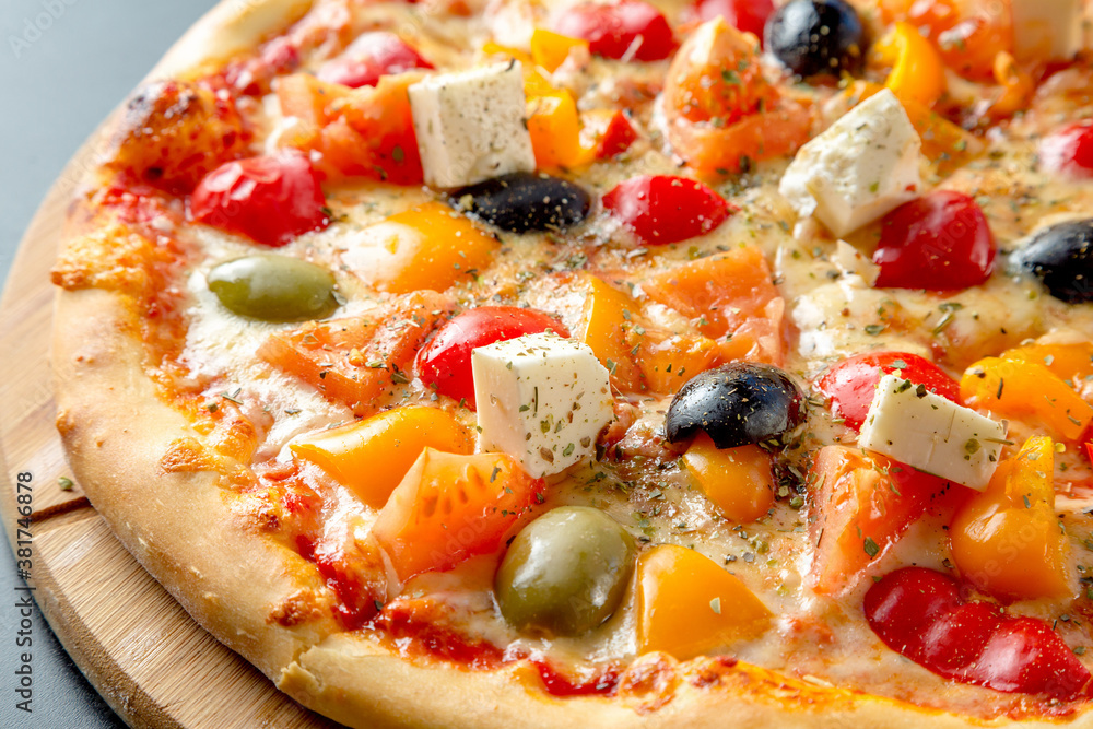Greek pizza with olives, bell peppers, feta cheese and tomatoes. Greek pizza with olives, bell peppers, feta cheese and tomatoes.