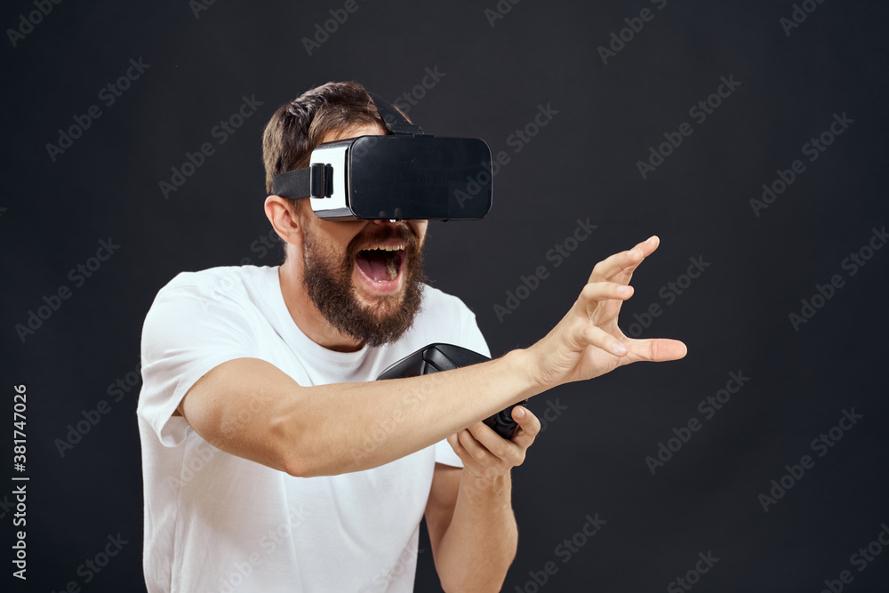 man wearing virtual reality glasses with gamepad in hand technology games leisure dark background man wearing virtual reality glasses with gamepad in hand technology games leisure dark background