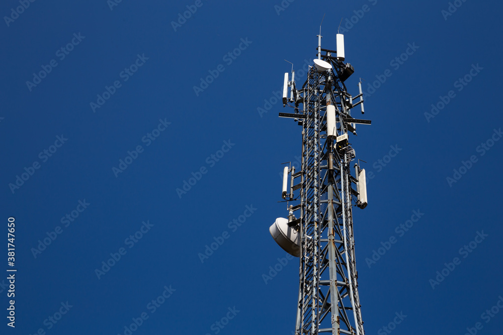 Mast of the cellular network over the blue sky Mast of the cellular network over the blue sky