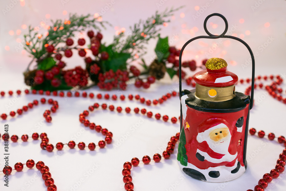 Obraz premium Christmas composition with ceramic lantern, red beads