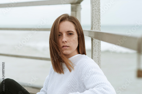 Young girl photographed on the beach on a rainy autumn day Free Download Young girl photographed on the beach on a rainy autumn day - GFXLoad