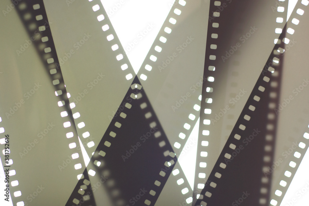 Photographic film background. 35mm negative film tapes on a white background.
