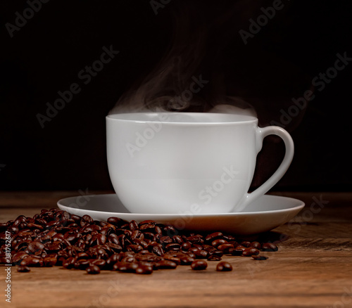 Freshly brewed coffee cup with coffee beans.
