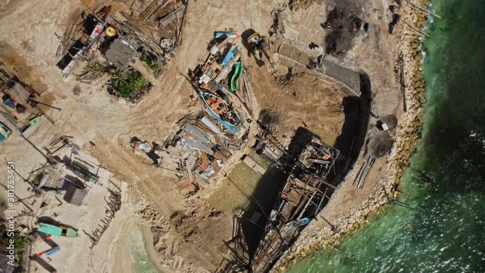 Video from the drone of the construction of a wooden boat on a sandy pier by the sea Video from the drone of the construction of a wooden boat on a sandy pier by the sea