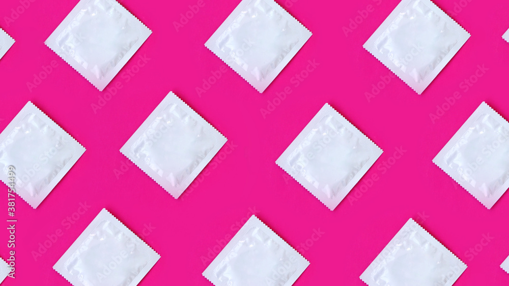 Many condoms in rows on pink background, collection, composition of condoms Many condoms in rows on pink background, collection, composition of condoms