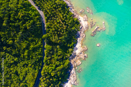 High angle view of road pass through coconut tree forest and beautiful coastline in Khanom, Nakhon si thammarat, Thailand.