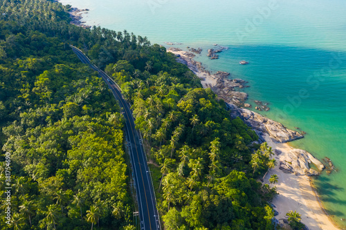 High angle view of  road pass through coconut tree forest and beautiful coastline in Khanom, Nakhon si thammarat, Thailand. photo