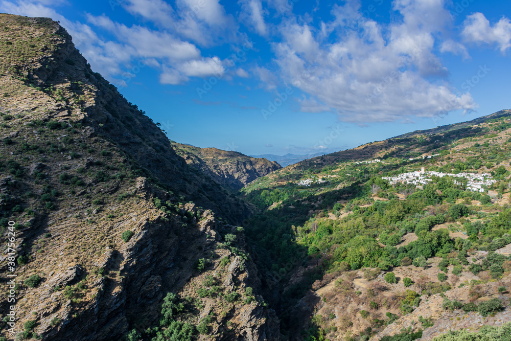 Fototapeta premium Views of the valley of the river Trevelez in the Granada Alpujarra with the town of Atalbeitar in the foreground.