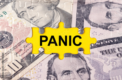 Puzzle with the image of dollars in the center of the inscription -PANIC