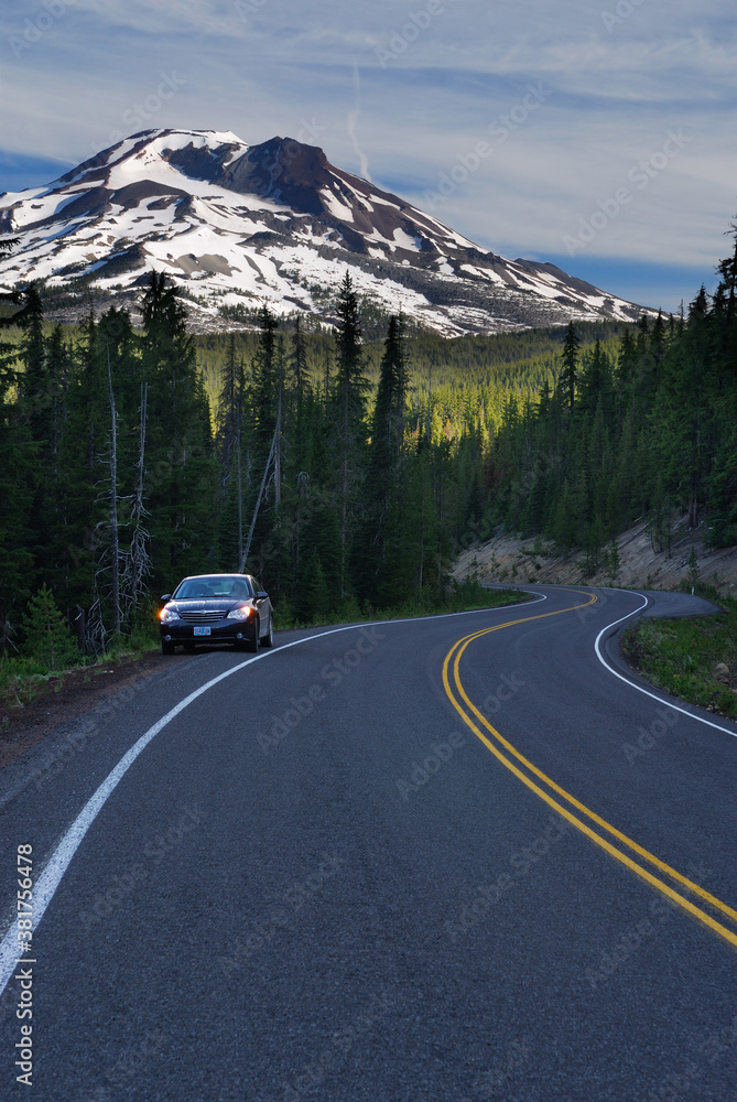 Car stopped on shoulder of Cascade Lakes Highway with South Sister Mountain