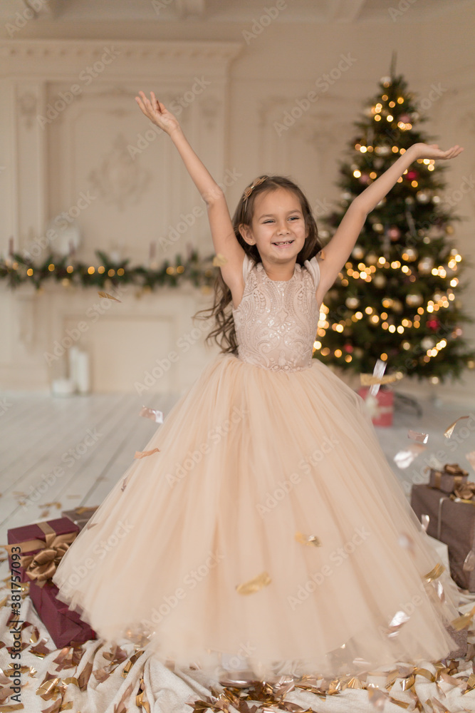 Fototapeta premium The little princess is enjoying the time of the Christmas holidays