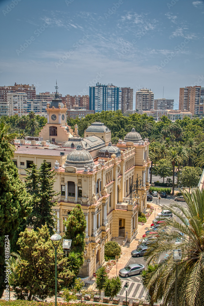 View of the city hall of the city of Malaga, surrounded by vegetation. Costa del Sol, Andalusia, Spain