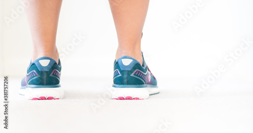 Teal blue running shoes - Jogging keeps you healthy - Young attractive woman's legs and shoes - Stay active