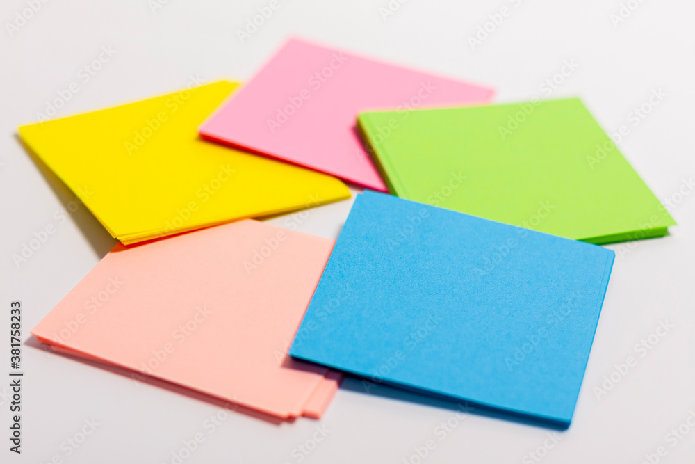 Sheets of paper of different colors are arranged in a circle. Side view. Sheets of paper of different colors are arranged in a circle. Side view.