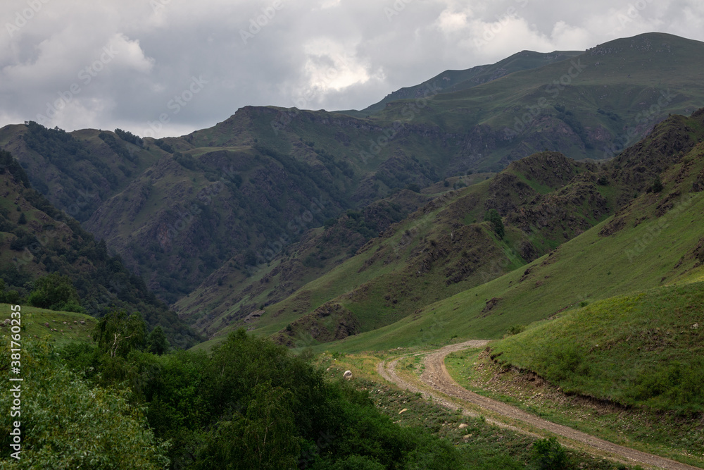 Mountain landscape with blue sky. Panoramic view of green hills. Mountain landscape with blue sky. Panoramic view of green hills.