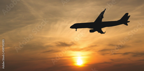 Commercial airplane during final approach. beautiful orange sky during sunset. Landing aircraft.