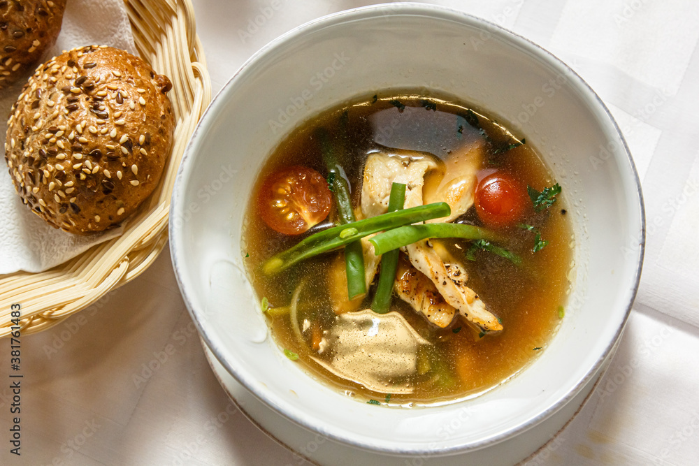 Concasse soup with chicken, tomatoes and green onions is on the plate Concasse soup with chicken, tomatoes and green onions is on the plate