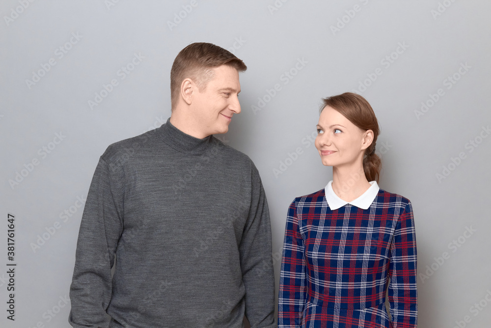 Portrait of happy man and woman looking at each other and smiling Portrait of happy man and woman looking at each other and smiling