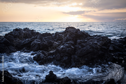 Sunset on rocky beach