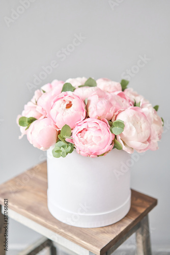 Pink peonies in pink round box. Beautiful peony for catalog or online store. Floral shop concept. Flowers delivery