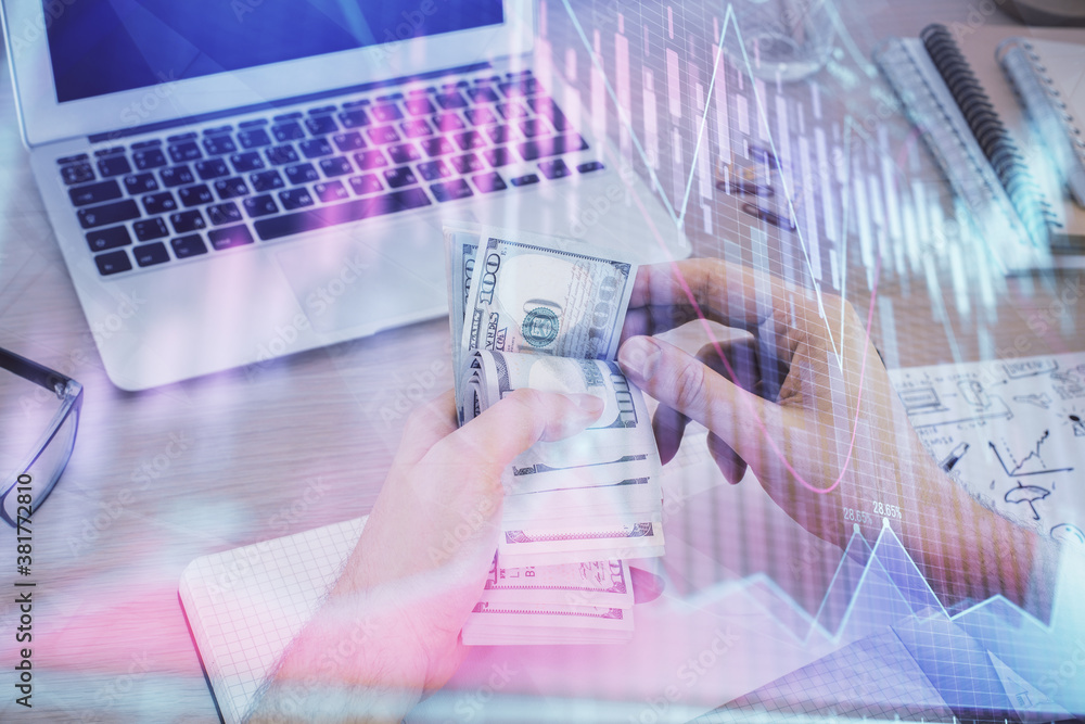 Multi exposure of financial graph drawing hologram and USA dollars bills and man hands. Analysis concept. Multi exposure of financial graph drawing hologram and USA dollars bills and man hands. Analysis concept.