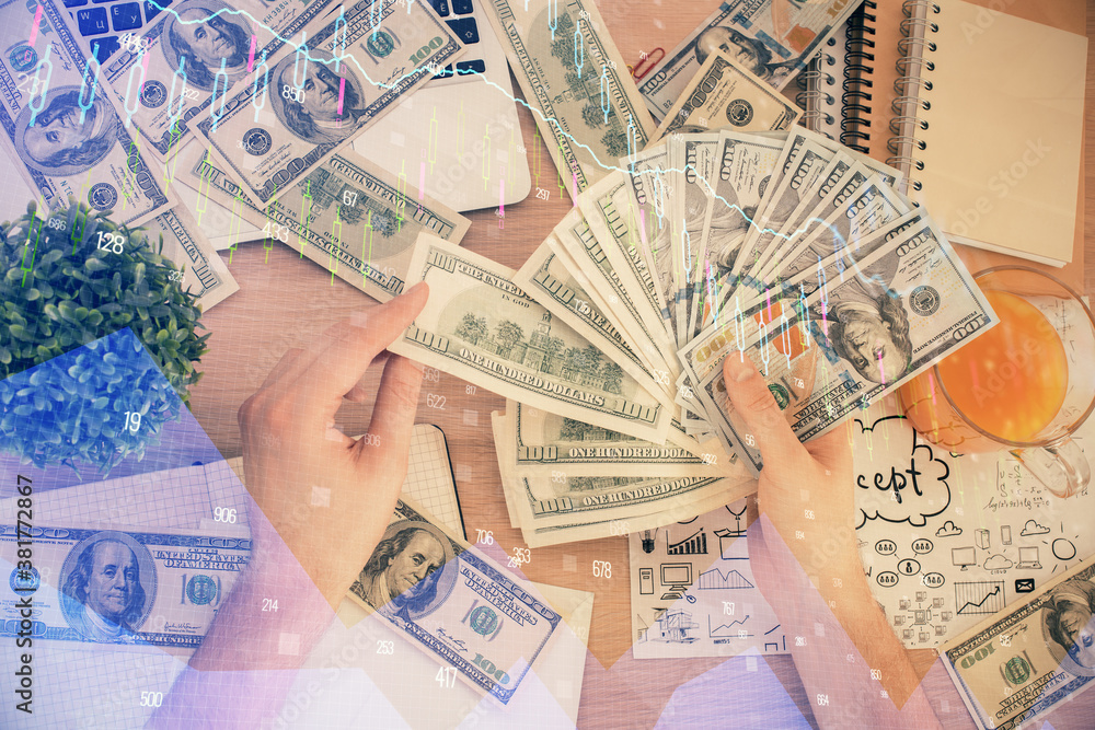 Multi exposure of financial graph drawing hologram and USA dollars bills and man hands. Analysis concept. Multi exposure of financial graph drawing hologram and USA dollars bills and man hands. Analysis concept.
