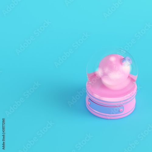 Pink snow globe with christmas bauble on bright blue background in pastel colors