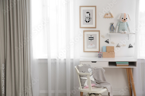 Stylish child's room interior with desk and beautiful pictures © New Africa