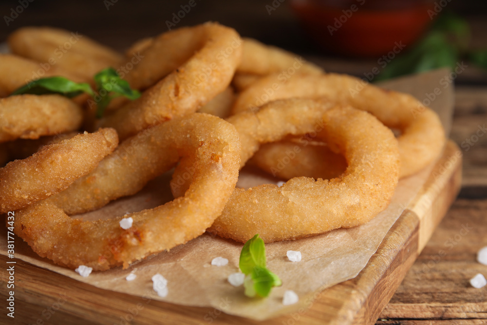 Delicious onion rings on wooden table, closeup Delicious onion rings on wooden table, closeup
