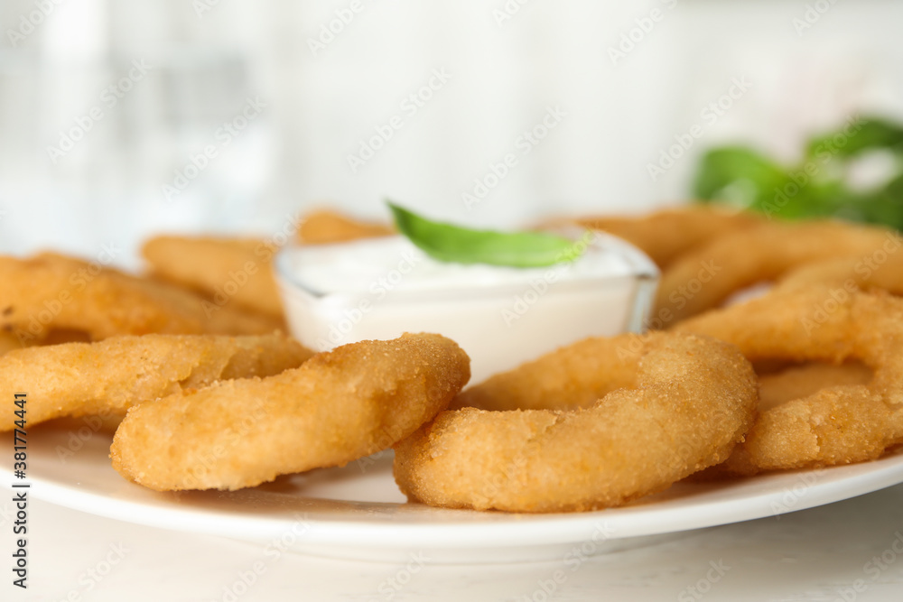 Delicious onion rings with sauce on white wooden table, closeup