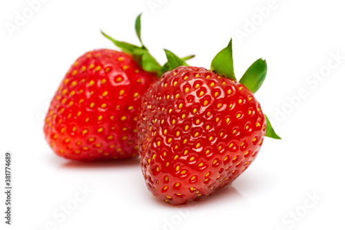 two ripe juicy strawberries on a white background