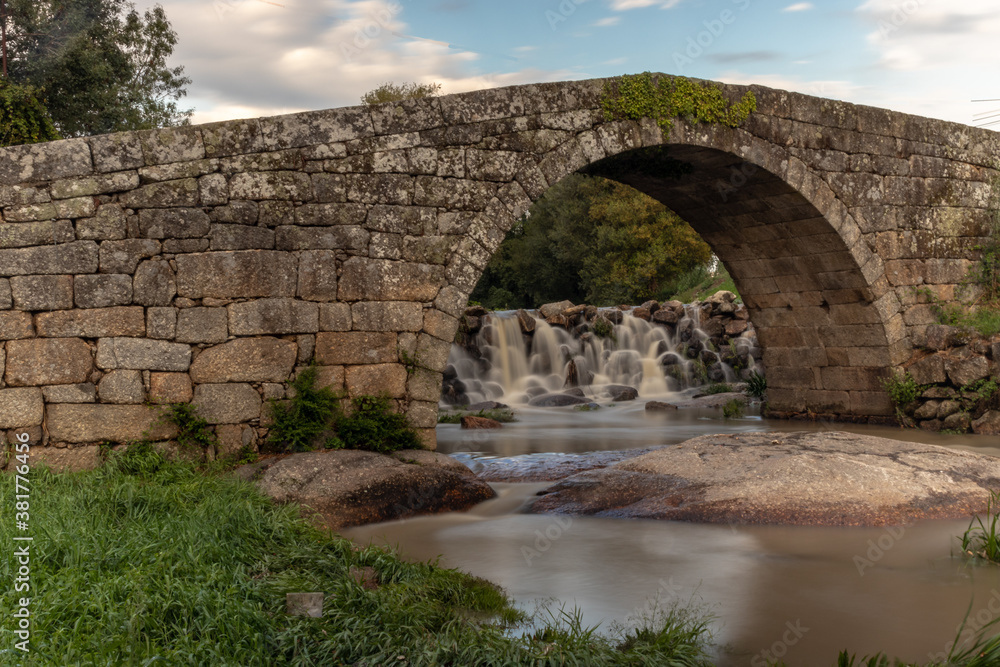 Old Roman bridge in the city of Viseu, with the river Pavia flowing under it, Long exposure of water, Viseu, Portugal