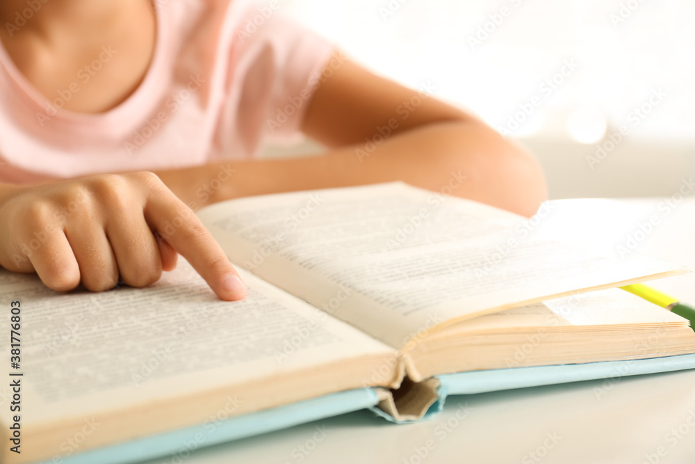 Little girl doing homework at table, closeup Little girl doing homework at table, closeup
