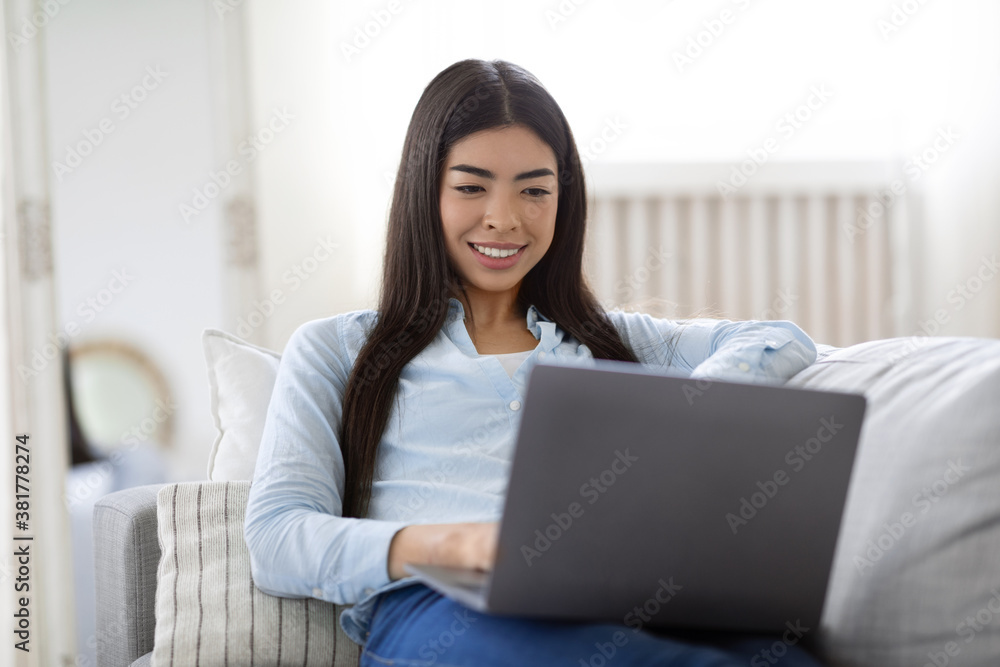 Internet Shopping. Happy Korean Woman Buying Things Online With Laptop At Home Internet Shopping. Happy Korean Woman Buying Things Online With Laptop At Home