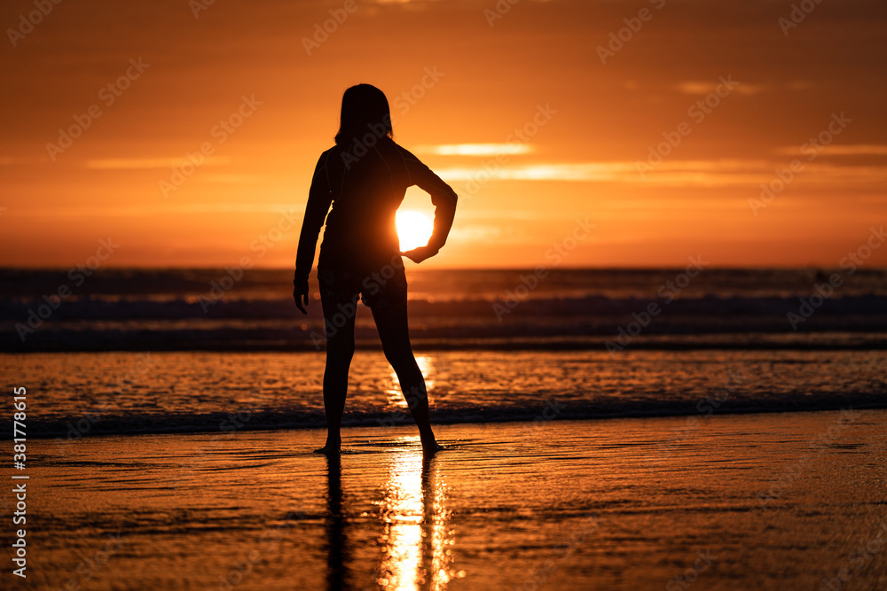 Silhouette and shadow shape of people is holding the sun before it setting down during the dramatic orange sunset period. Holiday relaxation and travel action photo.