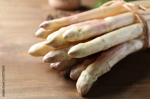 Bunch of fresh white asparagus on wooden table, closeup