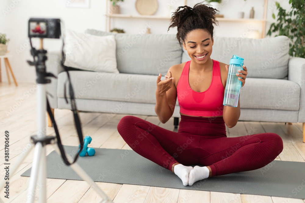 Fitness Blogger Woman Making Video Holding Bottle Of Water Indoor Fitness Blogger Woman Making Video Holding Bottle Of Water Indoor