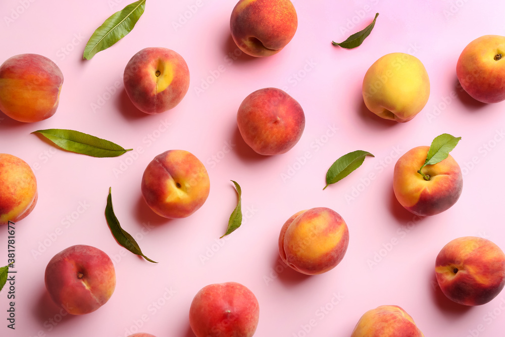 Fresh ripe peaches and green leaves on pink background, flat lay Fresh ripe peaches and green leaves on pink background, flat lay