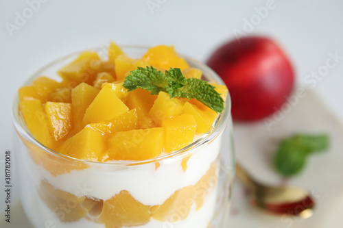 Tasty peach dessert with yogurt on table, closeup