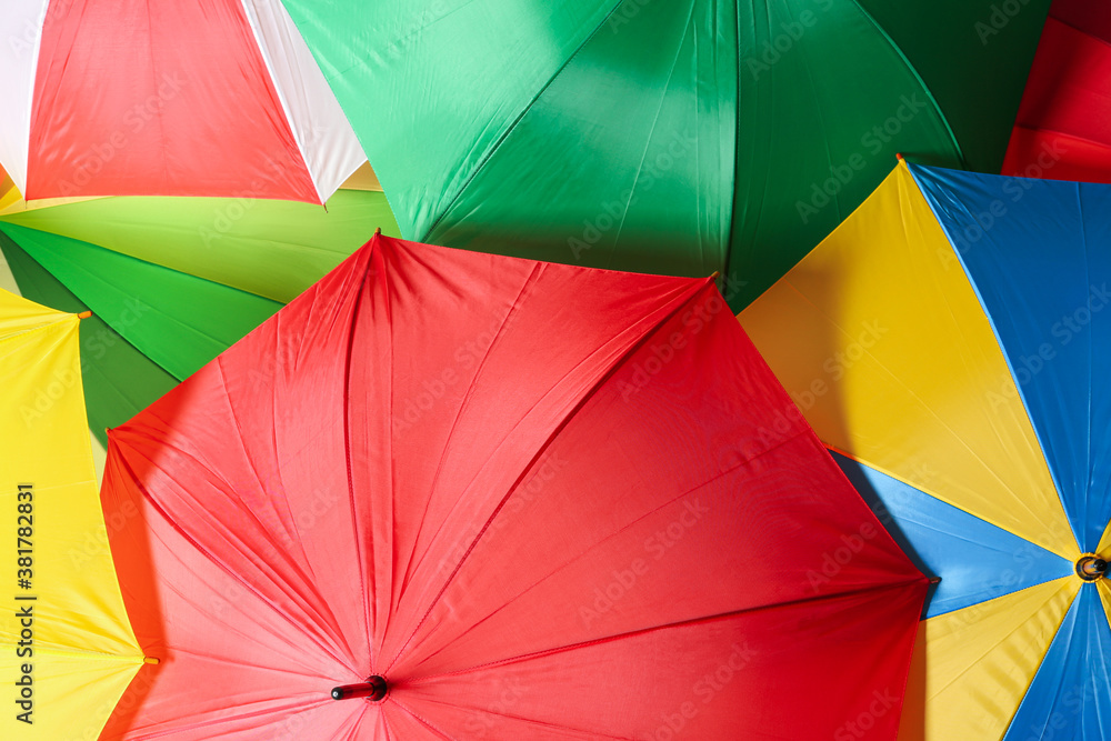 Many bright umbrellas as background, top view Many bright umbrellas as background, top view
