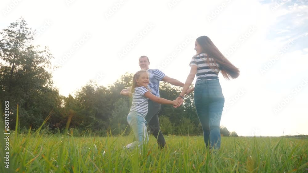 happy family mom dad and daughter play round dance. people in park kid dream concept. happy family parents with little kid child daughter play in the park on the grass lifestyle holding hands happy family mom dad and daughter play round dance. people in park kid dream concept. happy family parents with little kid child daughter play in the park on the grass lifestyle holding hands