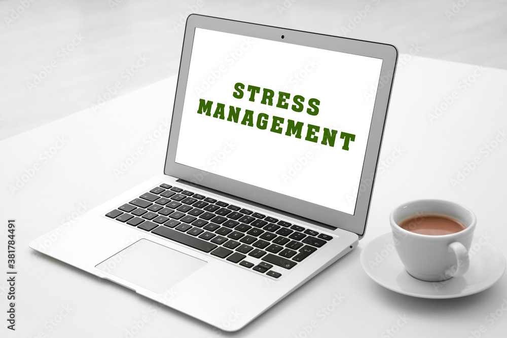 Laptop with text Stress Management on screen Laptop with text Stress Management on screen
