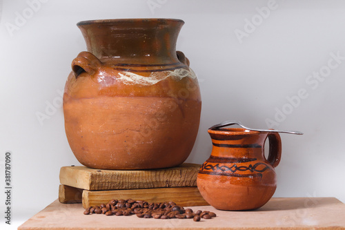 clay pot and jar accompanied by natural coffee beans