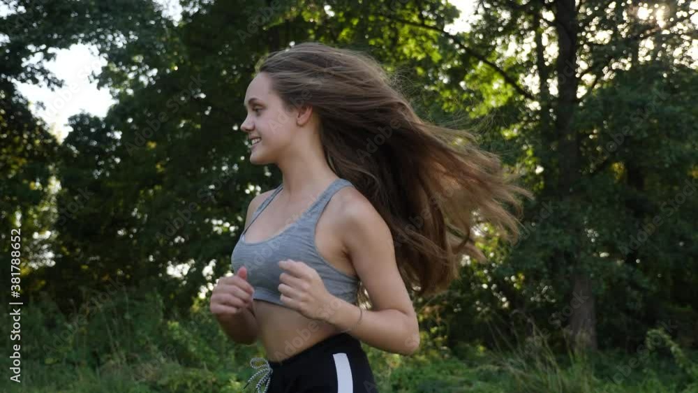girl runner runs in the park goes for sports. runner athlete girl running on trail nature. woman on morning jog green park healthy lifestyle people run park active concept girl runner runs in the park goes for sports. runner athlete girl running on trail nature. woman on morning jog green park healthy lifestyle people run park active concept
