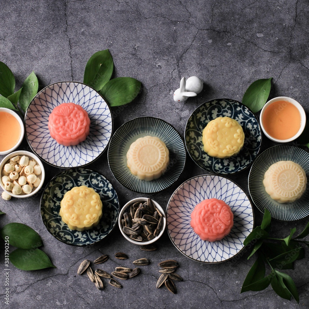 Colorful Snow Skin Moon Cake, Sweet Snowy Mooncake, Traditional Savory Dessert for Mid-Autumn Festival on Stone Background Colorful Snow Skin Moon Cake, Sweet Snowy Mooncake, Traditional Savory Dessert for Mid-Autumn Festival on Stone Background