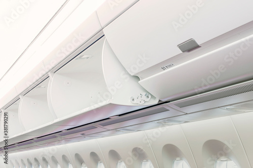 Photography Carry-on luggage in overhead storage compartment on commercial airplane